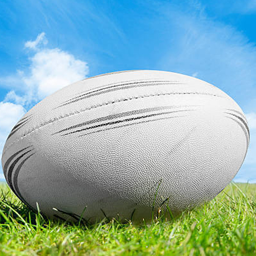 White rugby ball on a rugby pitch